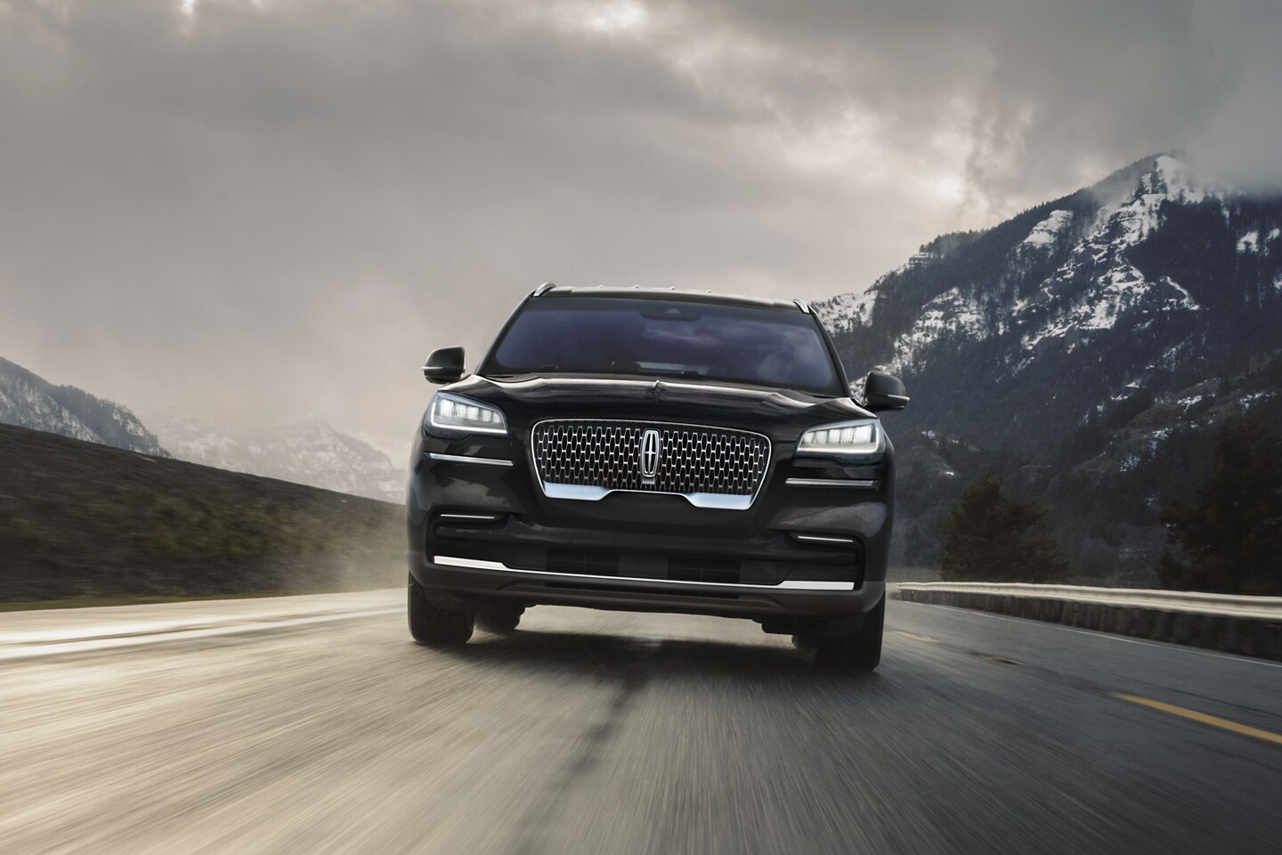 A 2022 Lincoln Aviator Grand Touring model is shown being driven on a mountain road