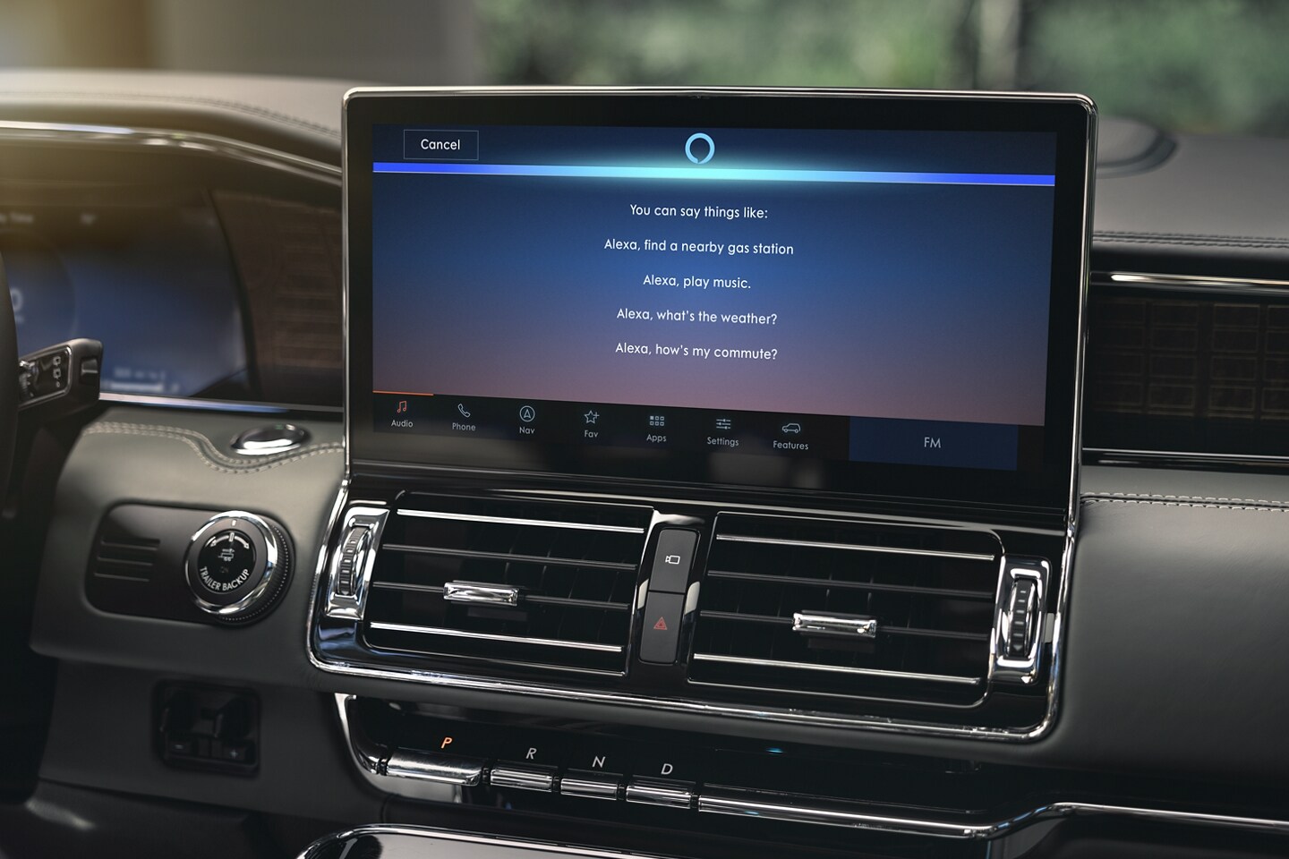 The “What can I say?” Amazon Alexa prompt screen is displaying on the 13.2-inch LCD centre screen waiting for a command.