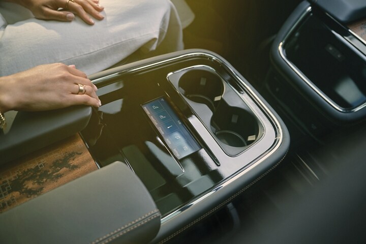 The rear digital touchscreen display and controls are cleanly integrated into the 2nd-row console