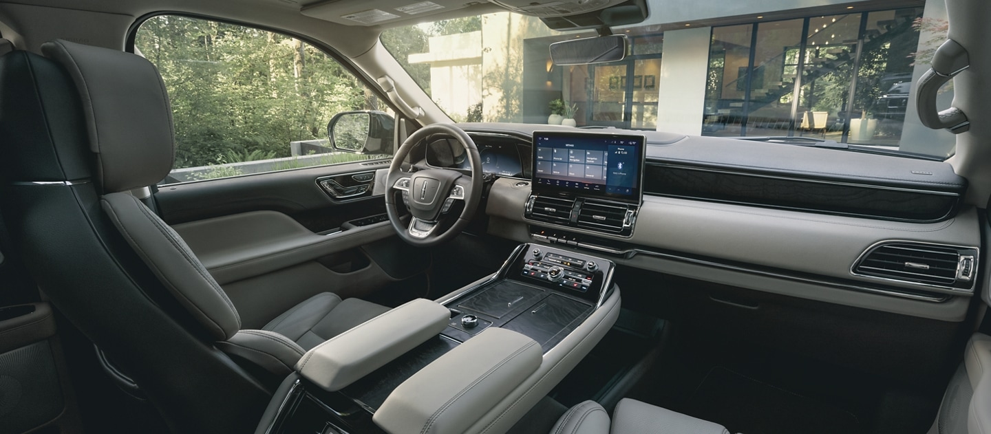 The front cabin of a 2024 Lincoln Navigator SUV shows off comfortable premium leather seating surfaces