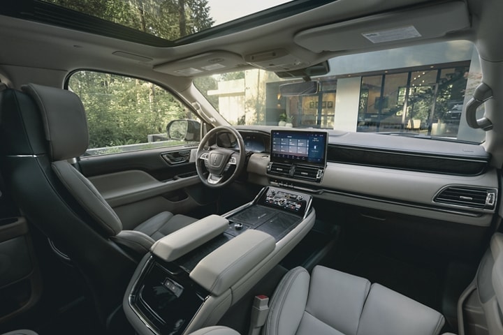 The front cabin of a 2024 Lincoln Navigator SUV shows off comfortable premium leather seating surfaces