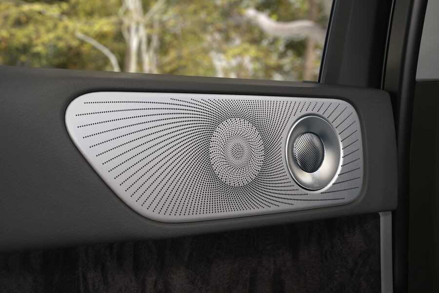 The inner door panel of a 2024 Lincoln Navigator SUV shows a collage of geometric shapes and textures