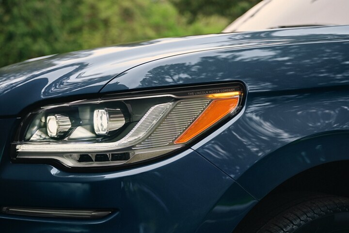 The LED headlamps on a 2024 Lincoln Reserve Navigator SUV show dynamic lines and bold form