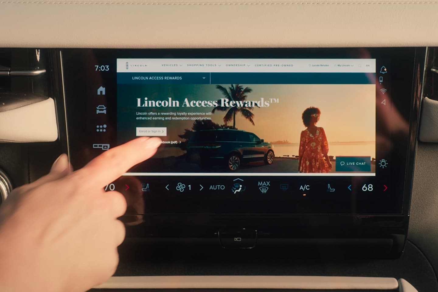 A person is using the centre touch screen of a 2025 Lincoln Navigator® to browse the internet