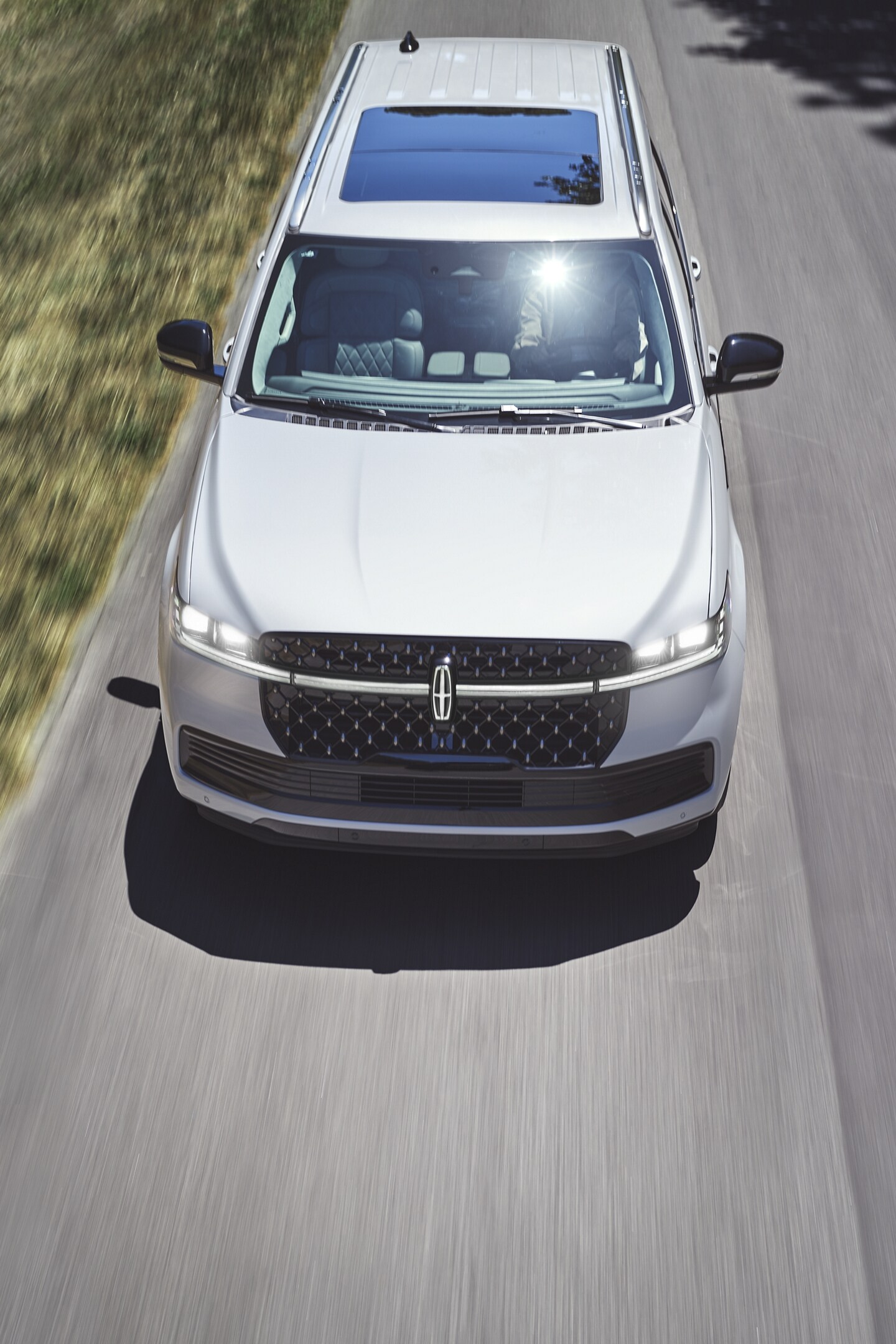 A 2025 Lincoln Black Label Navigator is being driven on a country road