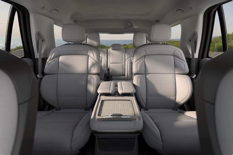 A young boy puts on his seat belt while seated in the third row of a 2025 Lincoln Navigator