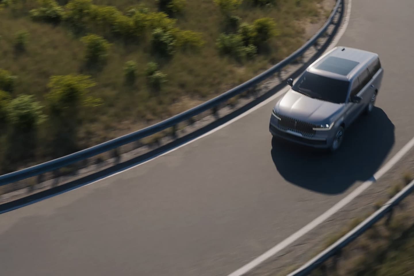 A 2025 Lincoln Navigator is being driven on a Blue Zone highway
